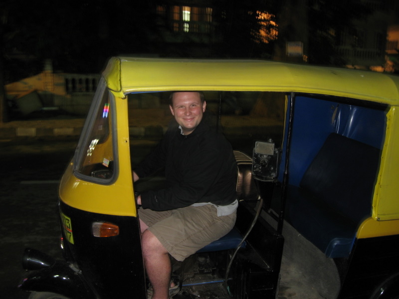 Zachary Tatlock driving an auto rickshaw